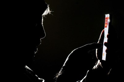 Foto: Joédson Alves/Agência Brasil Imagem escura de um homem mexendo no celular